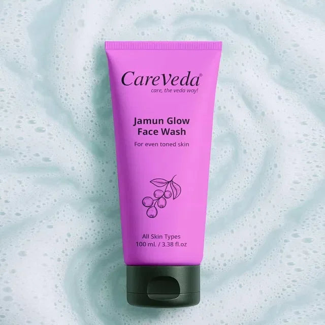 CareVeda Jamun Glow Face Wash for even toned skin, all skin types, 100ml tube on foamy background