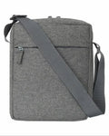 Gray textured crossbody bag with adjustable strap and front zipper pocket